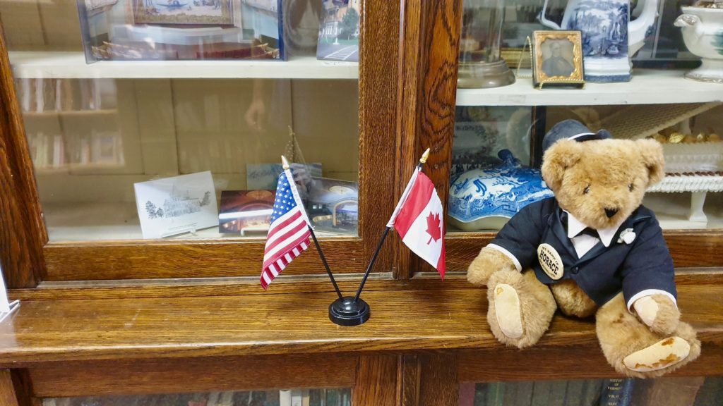 Miniature flags mark the spot of the US-Canada border inside the Haskell Free Library