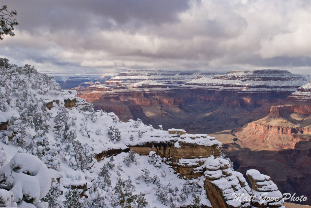 The canyon wall adds depth to a Grand Canyon snow photo