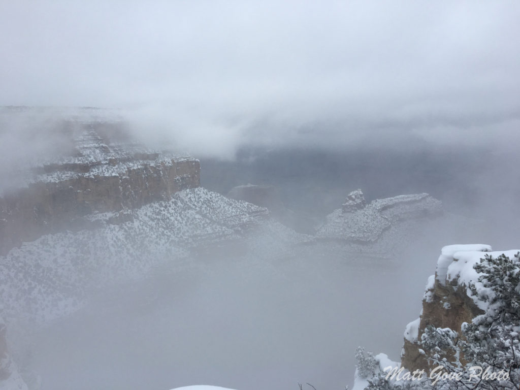 Clouds and snow obscure your view of the Grand Canyon