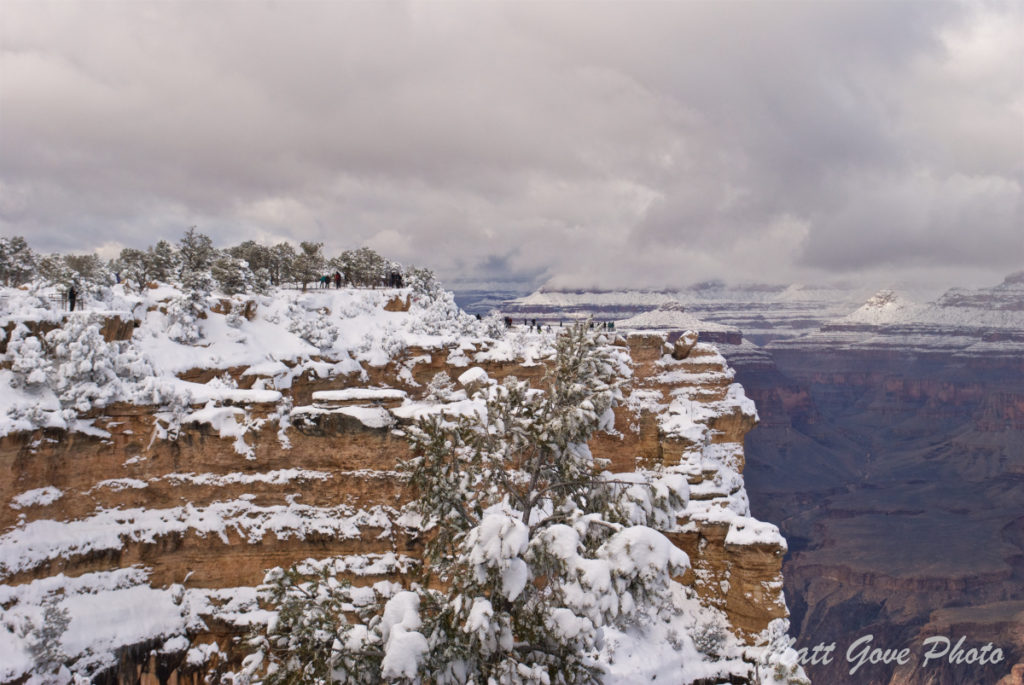 Tourists photograph the Grand Canyon after a snowstorm