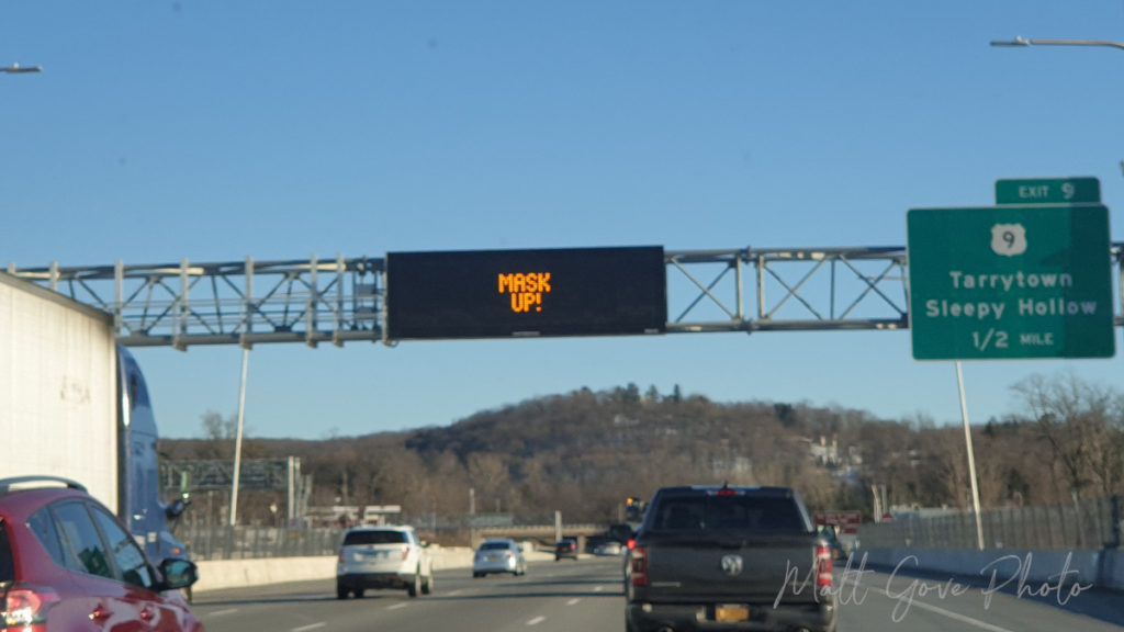 COVID-19 Mask Reminder on an electronic freeway sign in New York