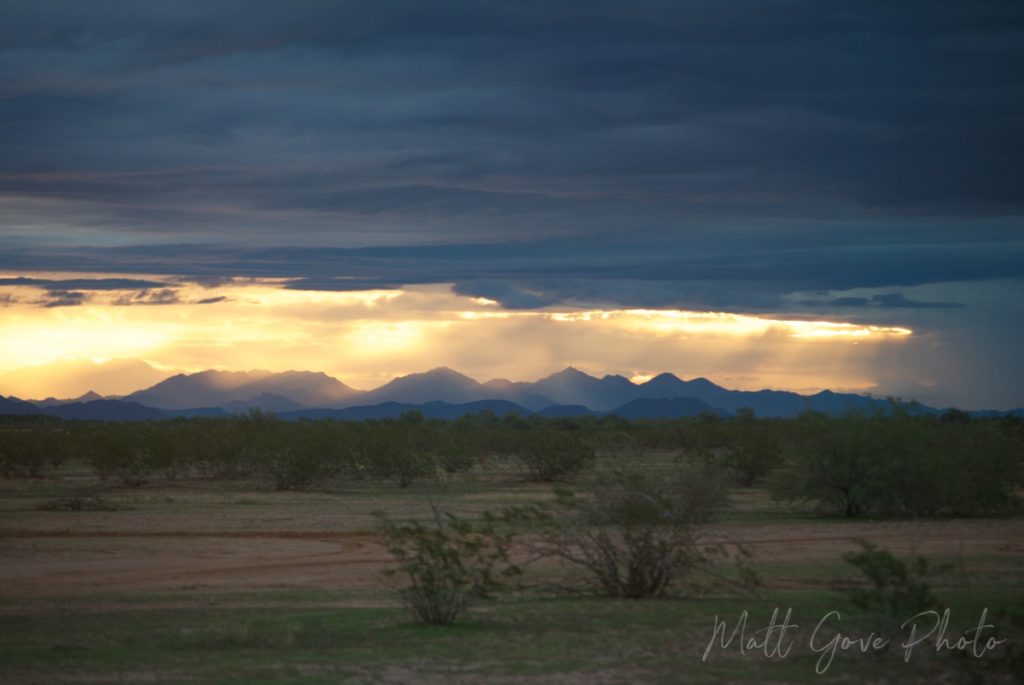 Low sunlight shines on Arizona's White Tank mountains as a storm clears out of the area.