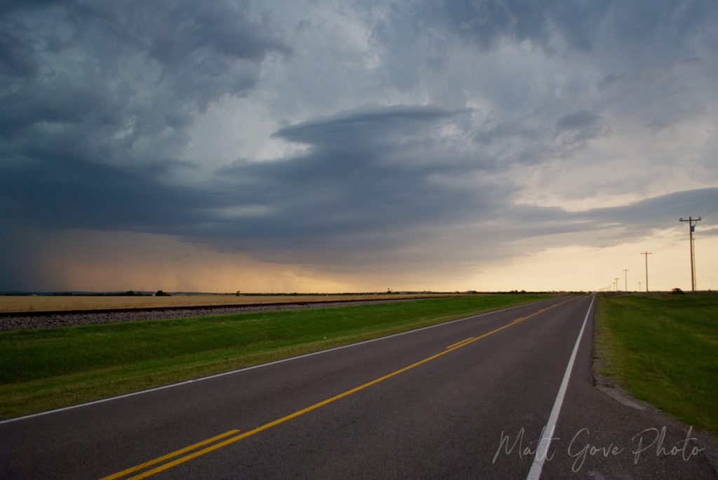 A severe thunderstorm approaches Amber, Oklahoma at sunset.