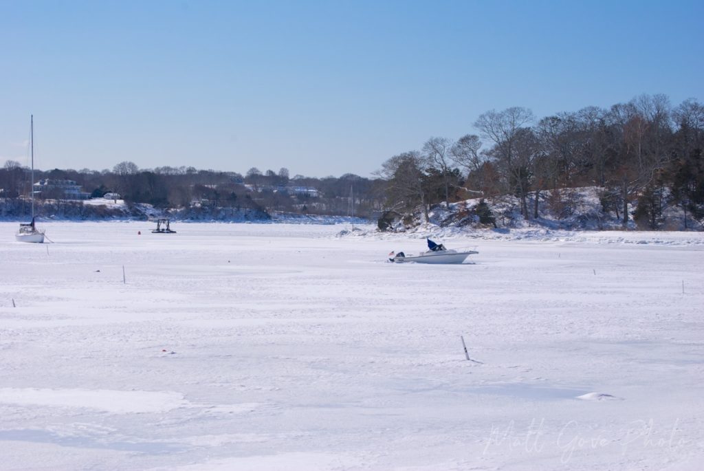 Quissett Harbor is frozen over after a blizzard.