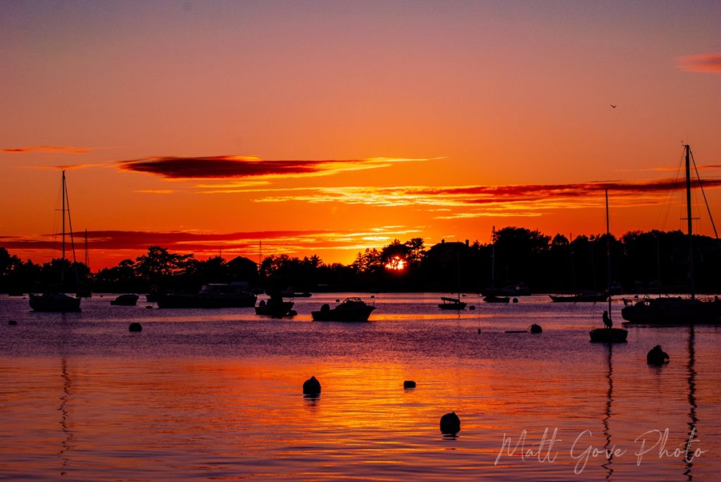 Use weather forecasting to chase sunsets like this one over Great Harbor in Woods Hole, MA