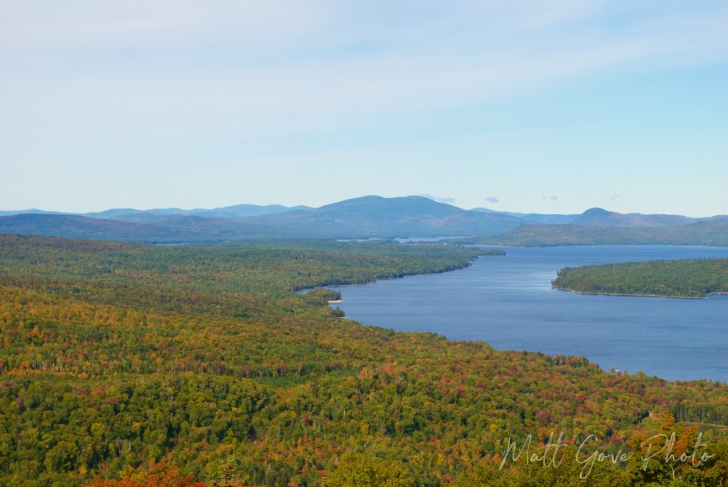 A mountain landscape is lit up with brilliant fall colors in Maine
