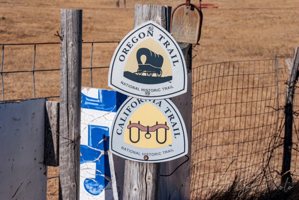 Placards marking the Oregon Trail and California Trail are nailed to a fence at the California Hill parking area.